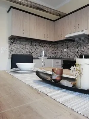 a kitchen table with a plate and a wine glass at Anatoli View in Agia Marina Nea Kydonias