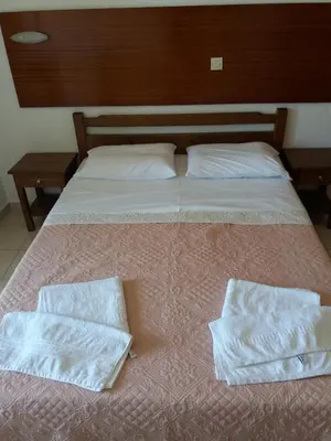 a bed with two pillows on top of it at Oasis Studios in Palaiochóra