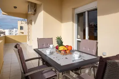 a table with a bowl of fruit on a balcony at Casa di Halepa in Chania Town