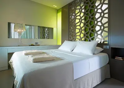 a bedroom with a bed with two towels on it at Youphoria Sea View Villas in Kissamos