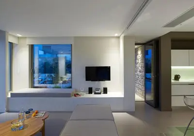 a living room with a bed and a tv at Youphoria Sea View Villas in Kissamos