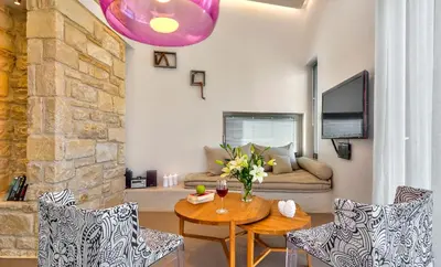 a living room with a table and chairs at Youphoria Sea View Villas in Kissamos