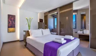 a bedroom with a large bed with towels on it at Youphoria Sea View Villas in Kissamos