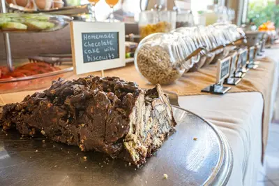a piece of chocolate cake on a plate on a table at Helios Apartments in Kato Daratso