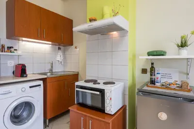 a kitchen with a washing machine and a washer at Elita beachfront in Chania Town
