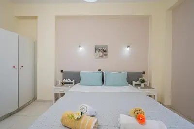 a bedroom with a bed with two stuffed animals on it at Elita beachfront in Chania Town