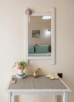 a dressing table with a mirror on a wall at Elita beachfront in Chania Town