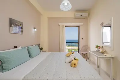 a bedroom with a bed with two stuffed animals on it at Elita beachfront in Chania Town