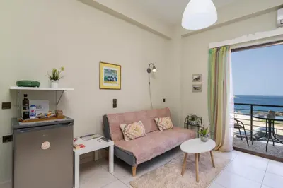 a living room with a couch and a view of the ocean at Elita beachfront in Chania Town