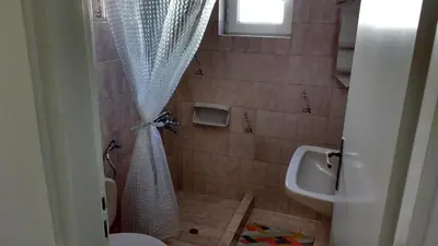 a bathroom with a shower and a toilet and a sink at Elita Beachside in Chania Town