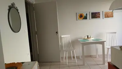 a kitchen with a table and chairs and a mirror at Elita Beachside in Chania Town
