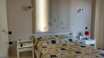 a bedroom with a bed and two night stands at Elita Beachside in Chania Town