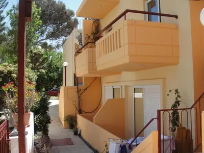 a building with stairs on the side of it at Leonidas Rooms in Plataniás