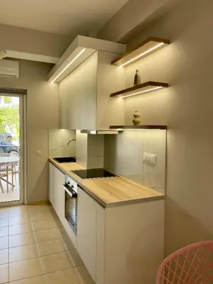 a kitchen with white cabinets and a counter top at Thea Artemis in Kato Daratso