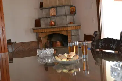 a table with a bowl of bread and a fireplace at Villa Eternity in Alikampos