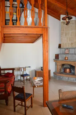a living room with a couch and a fireplace at Villa Eternity in Alikampos
