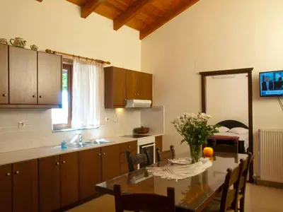 a kitchen with a table and a dining room at Villa Eternity in Alikampos