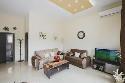 a living room with two couches and a flat screen tv at Spacious Home with Parking in Chania Town