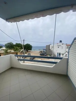 a balcony with a view of the ocean at Adamas Rooms in Palaiochóra