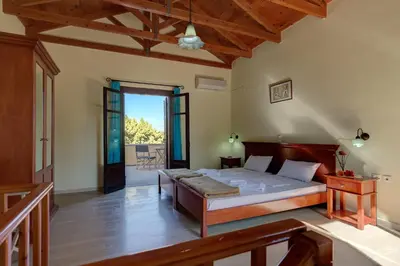 a bedroom with a large bed in a room at Crete holiday rental small village close to beaches -sharing a large pool in Vamos