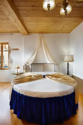 a large bed in a room with a wooden ceiling at Casa Perla Suites in Chania Town