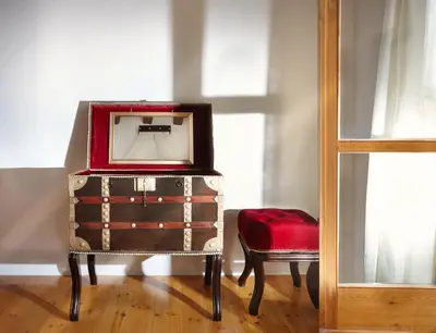 a mirror on top of a dresser with a red chair at Casa Perla Suites in Chania Town