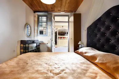 a bedroom with a large bed in a room at Casa Perla Suites in Chania Town
