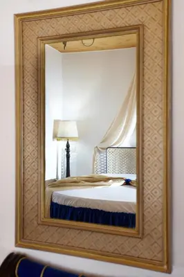 a mirror reflecting a bed in a room at Casa Perla Suites in Chania Town