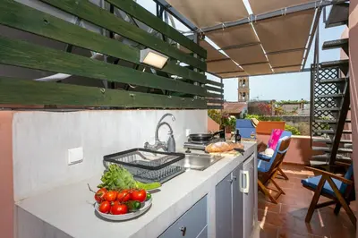 a kitchen with a counter with vegetables on it at La Barchetta Old Town Home with Seaview in Chania Town