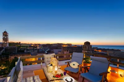 a view of a balcony with chairs and a table at La Barchetta Old Town Home with Seaview in Chania Town