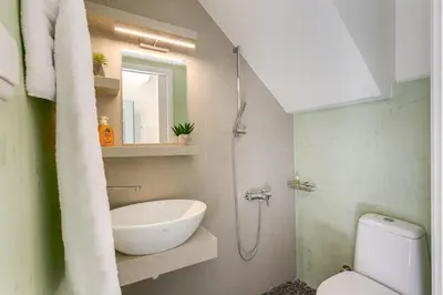 a bathroom with a shower and a sink and a toilet at La Barchetta Old Town Home with Seaview in Chania Town