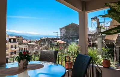 a balcony with a table and chairs and a view at Sophia's Castle View Apartment in Chania Town