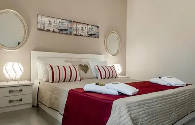 a bedroom with a bed with two towels on it at Sophia's Castle View Apartment in Chania Town