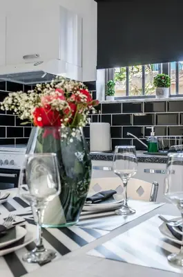 a vase of flowers on a table in a kitchen at Sophia's Castle View Apartment in Chania Town