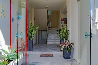 a hallway with potted plants in a building at Saint Trope Studios in Kalamaki Chanion