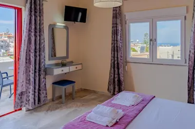 a bedroom with a bed and a window at Saint Trope Studios in Kalamaki Chanion