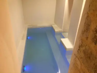 a bathroom with a tub with blue lights at Antica Canea Luxury Rooms in Chania Town