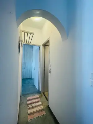 an empty hallway with an archway and a door at Waves House in Kissamos