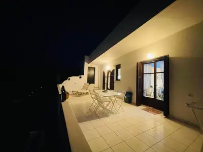 a living room with a table and chairs in a room at Waves House in Kissamos