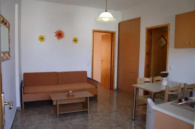 a living room with a couch and a table at Kochyli Studios in Palaiochóra