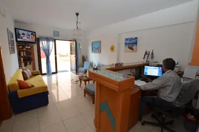 a man sitting at a desk in front of a computer at Kochyli Studios in Palaiochóra