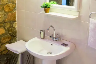a white sink in a bathroom with a window at Villa Livadia with Pool, close to Elafonissi famous Beach in Livadia