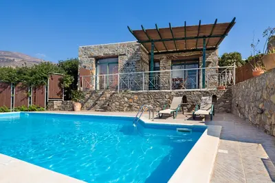 a villa with a swimming pool and a house at Villa Livadia with Pool, close to Elafonissi famous Beach in Livadia