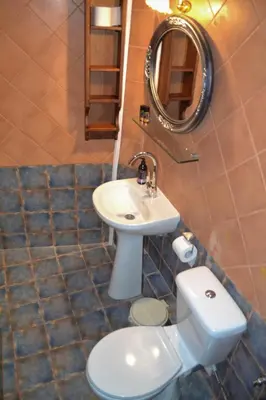a bathroom with a toilet and a sink and a mirror at Yro Studios in Chania Town