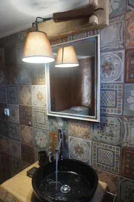 a bathroom with a sink and a mirror and lights at Seas the view in Chania Town