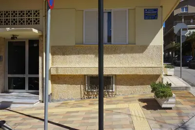 a reflection of a building with a window on a street at Seas the view in Chania Town