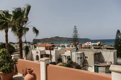 a view of a town with houses and palm trees at Heaven Apartments in Agia Marina Nea Kydonias