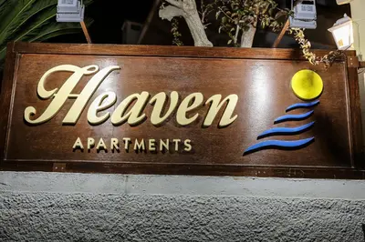 a sign for a restaurant with a mermaid on it at Heaven Apartments in Agia Marina Nea Kydonias