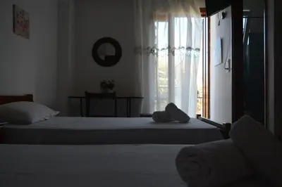 a bedroom with two beds and a window at Poseidon Studios Chania Center in Chania Town