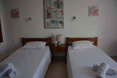 two beds sitting next to each other in a room at Poseidon Studios Chania Center in Chania Town